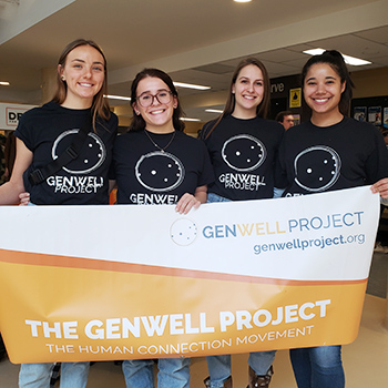 Executive members of GenWell Project Laurier holding banner