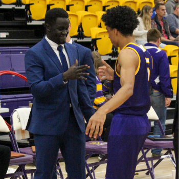 Chuder Teny with a Laurier basketball player