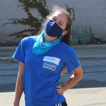 Young woman wearing a blue face mask and t-shirt