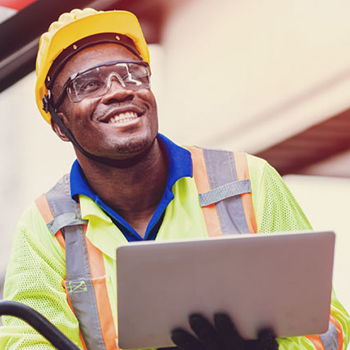 Construction worker holding laptop