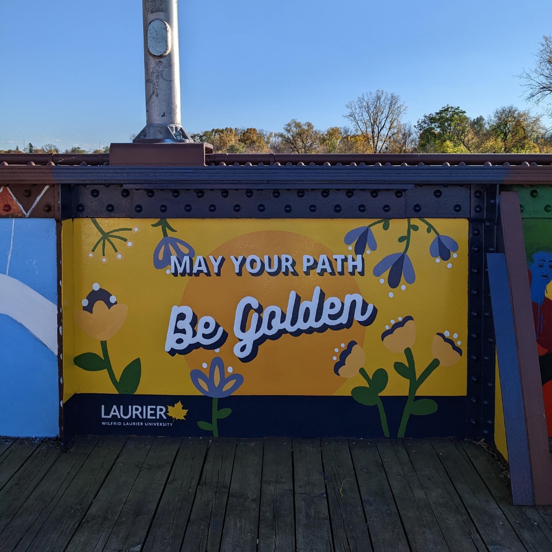 purple and gold mural that reads, May Your Path Be Golden
