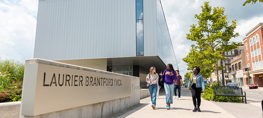 Laurier students walk past YMCA sign